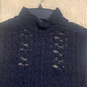 Black lace lined sleeveless high neck top.